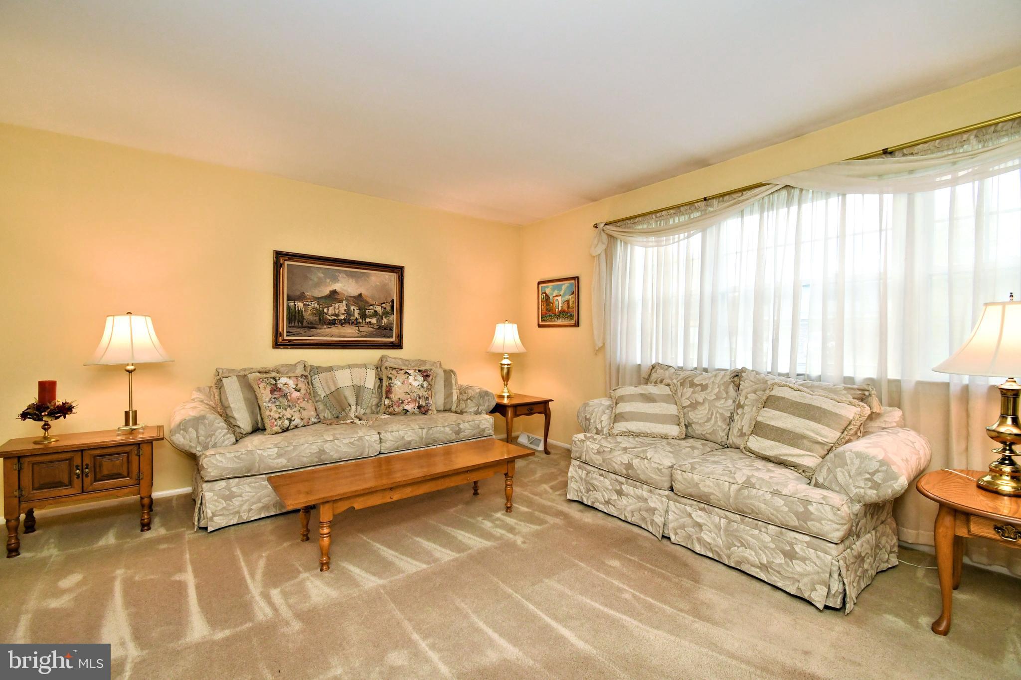 545 Brook Lane Warminster, PA 18974 - Photo 5 of 25 a living room with furniture and a lamp