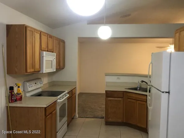 a kitchen with a refrigerator and a sink