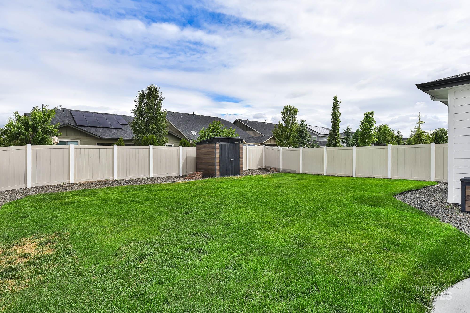 5676 East Zaffre Ridge Street Boise, ID 83716 - Photo 47 of 50 Expansive green lawn with a perimeter gravel bed