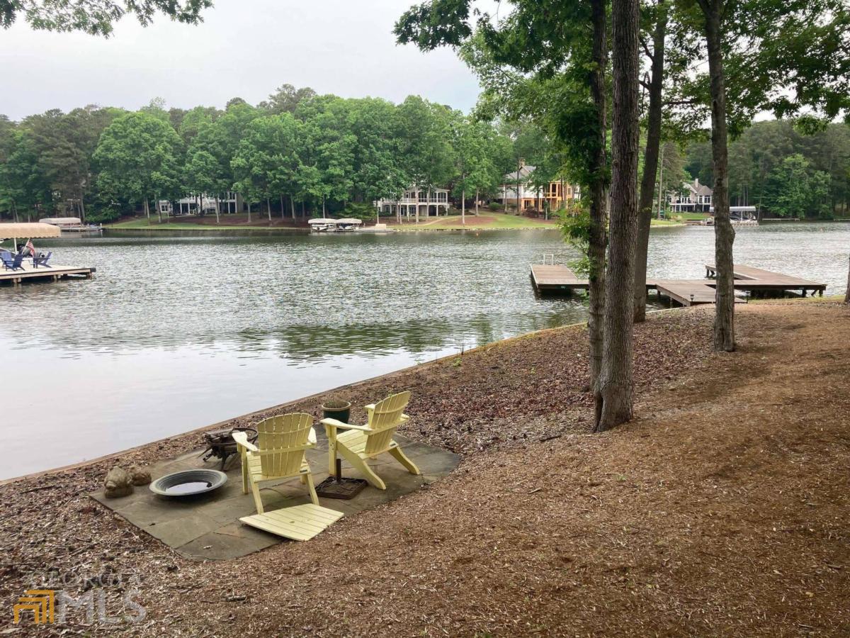 a view of a lake with a table and chairs