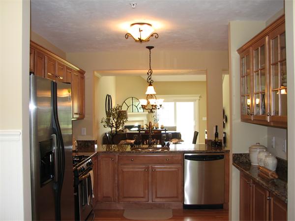 11 C Trail Ridge Way, Unit 35 Harvard, MA 01451 - Photo 5 of 30 a kitchen with counter top space and stainless steel appliances