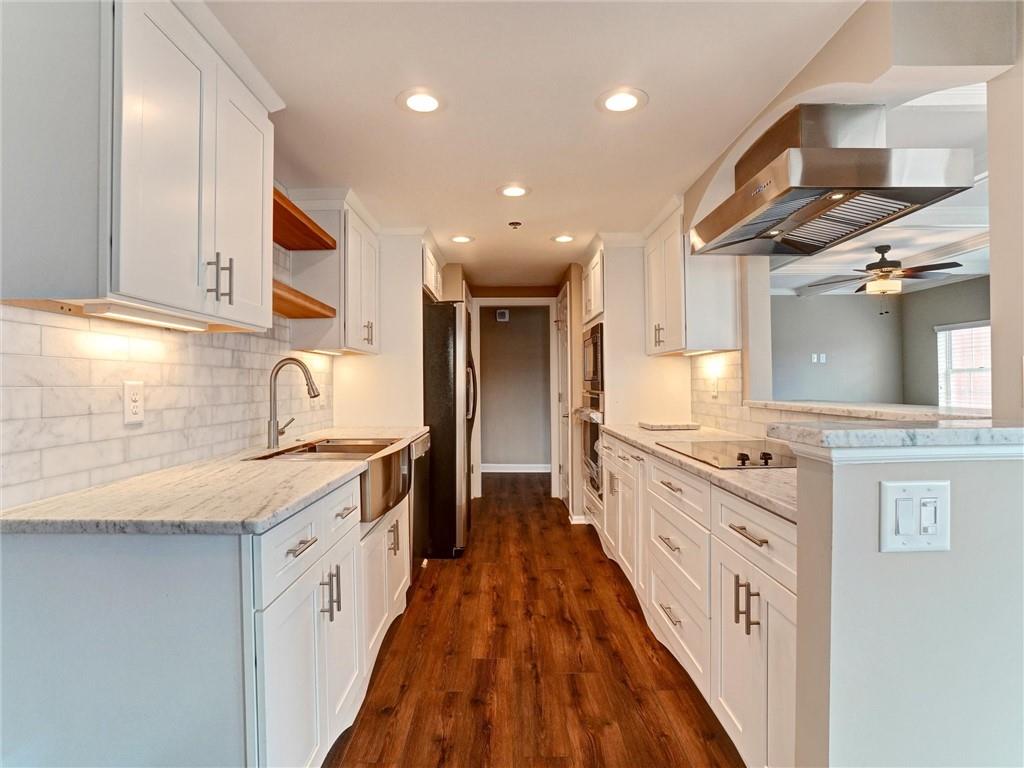 3435 Kingsboro Road Northeast, Unit 1601 Atlanta, GA 30326 - Photo 8 of 54 a large kitchen with stainless steel appliances granite countertop a lot of counter space and a sink