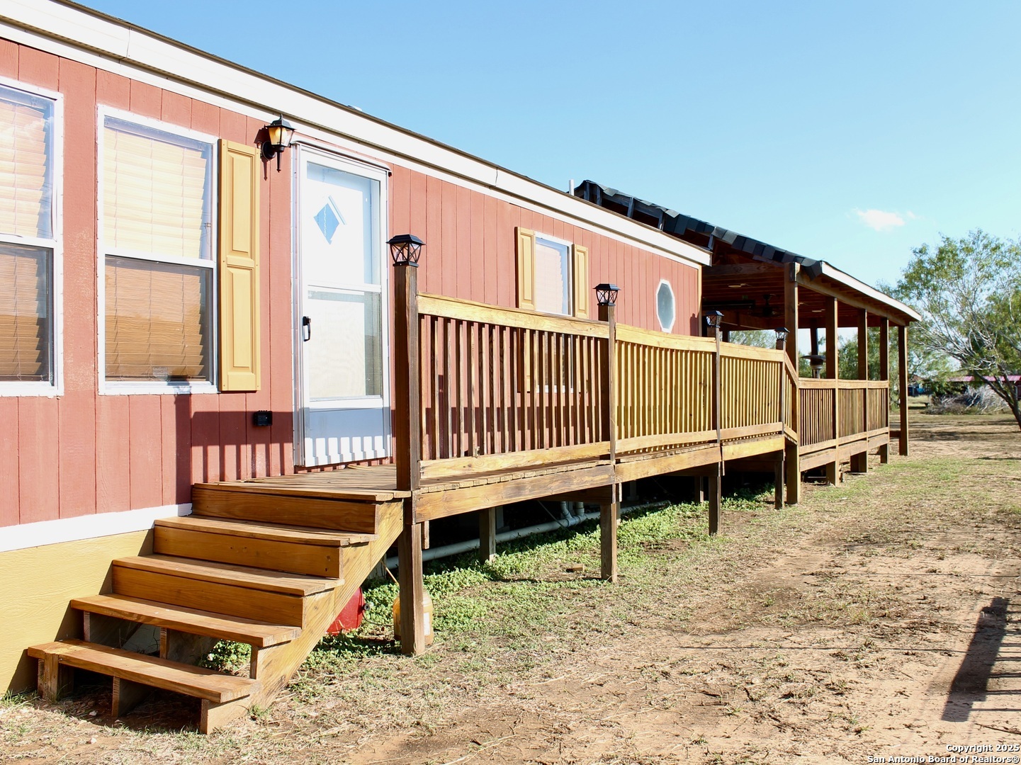 a view of a house with a wooden deck