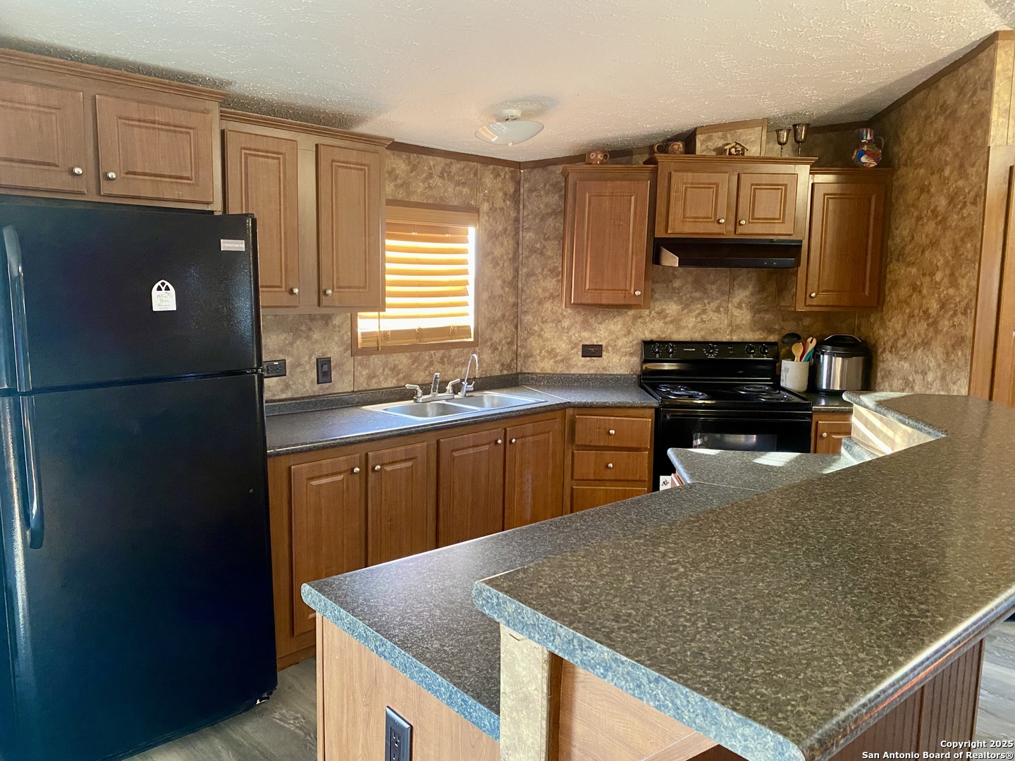 13014 Bernhardt Road San Antonio, TX 78263 - Photo 11 of 29 a kitchen with stainless steel appliances granite countertop a sink a stove a refrigerator a microwave a counter top and cabinets