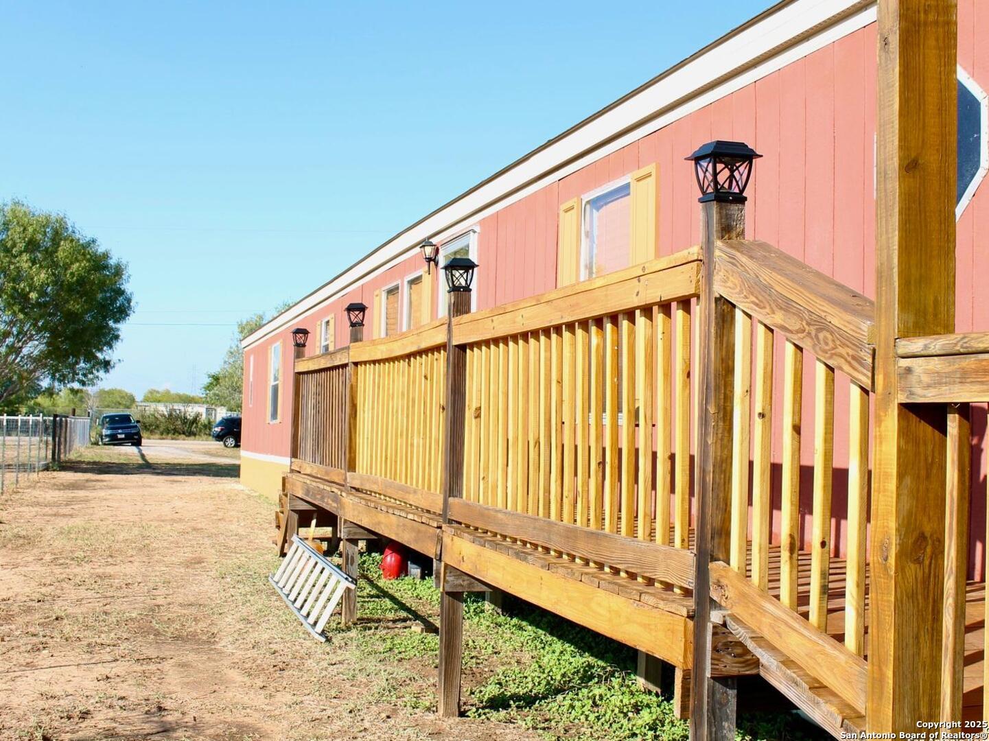 13014 Bernhardt Road San Antonio, TX 78263 - Photo 3 of 29 a view of a street with wooden fence
