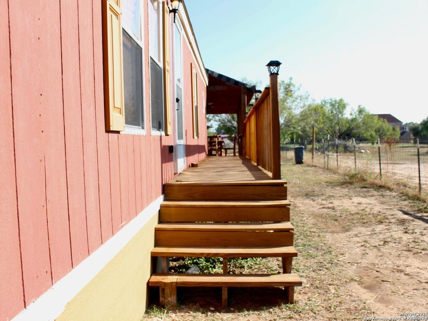 13014 Bernhardt Road San Antonio, TX 78263 - Photo 4 of 29 a view of staircase with white walls and a window