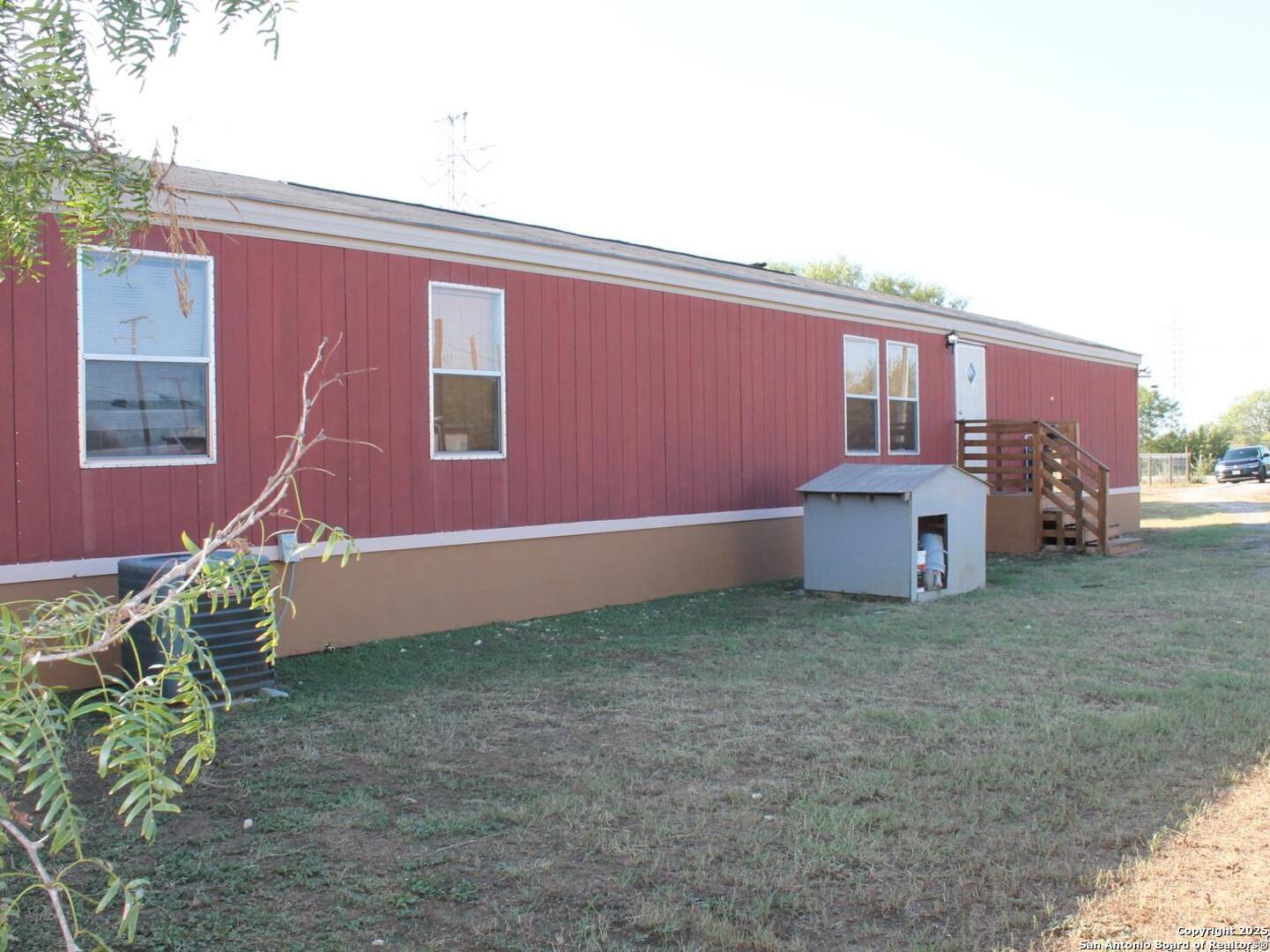 13014 Bernhardt Road San Antonio, TX 78263 - Photo 5 of 29 a house with a bench in front of it