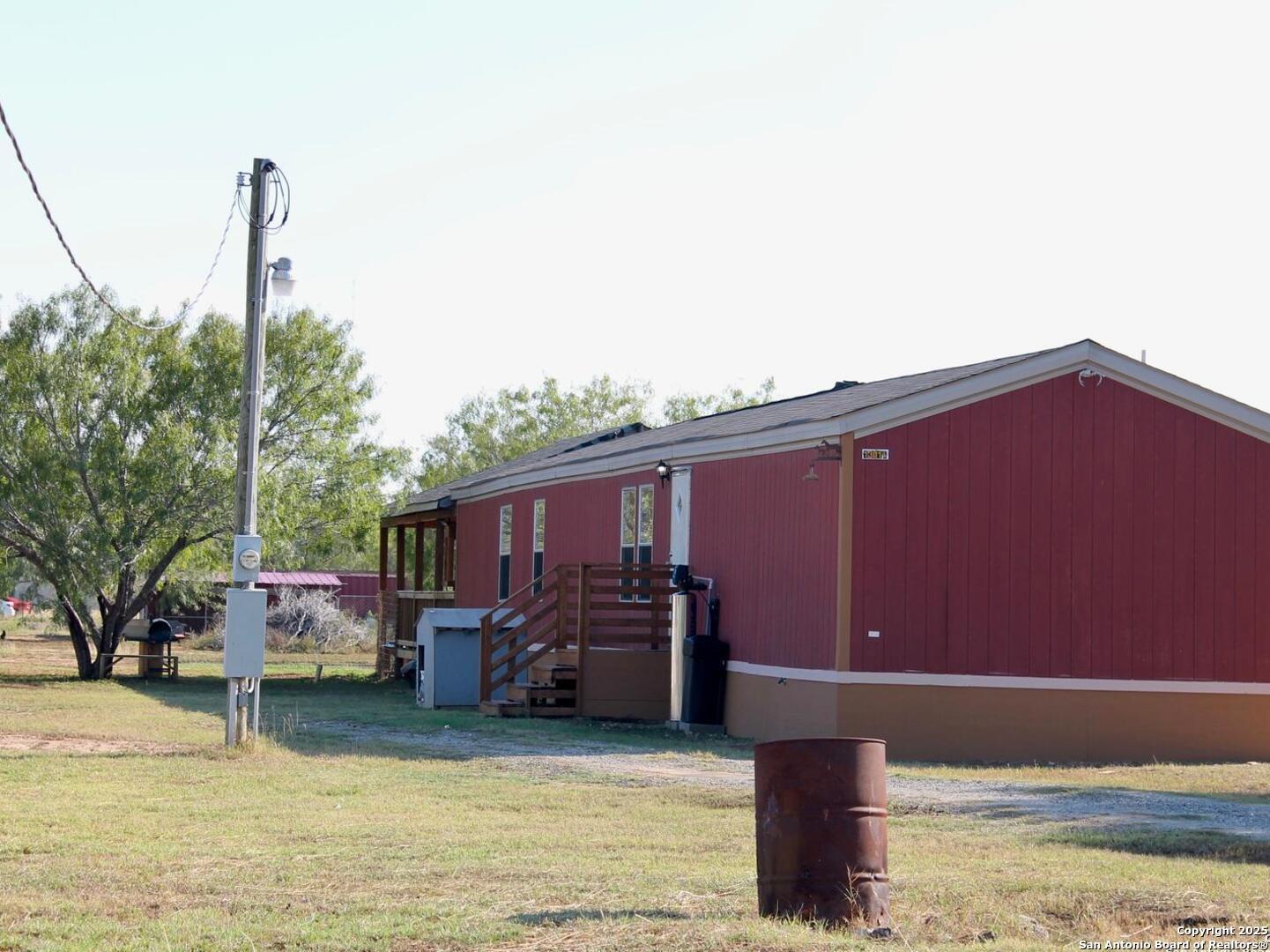 13014 Bernhardt Road San Antonio, TX 78263 - Photo 6 of 29 a backyard of a house with yard table and chairs