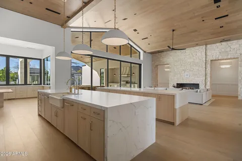 a large white kitchen with a large window