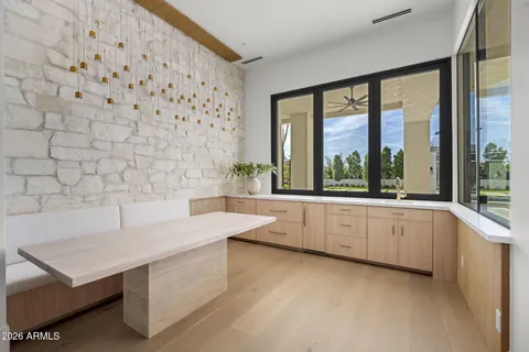 a bedroom with furniture and a large window