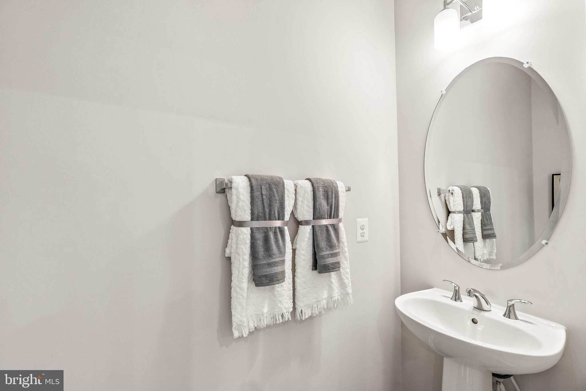 7033 Whispering Run Brandywine, MD 20613 - Photo 6 of 26 a bathroom with a sink and mirror