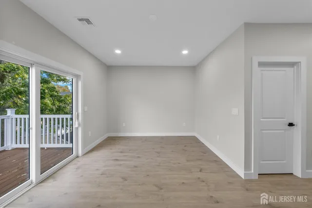 a view of backyard with a deck and wooden floor
