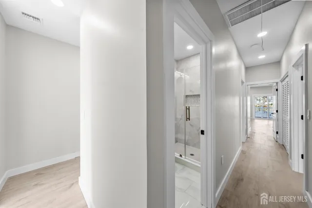 a bathroom with a granite countertop sink a toilet and shower