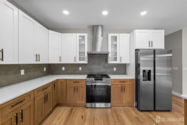a kitchen with a refrigerator a sink and wooden cabinets