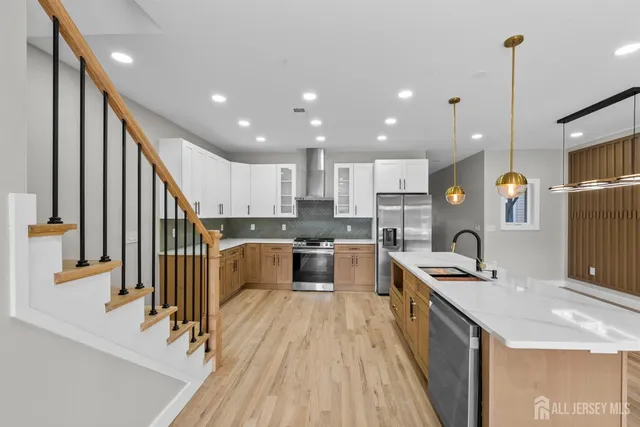 a kitchen with counter top space a sink appliances and cabinets