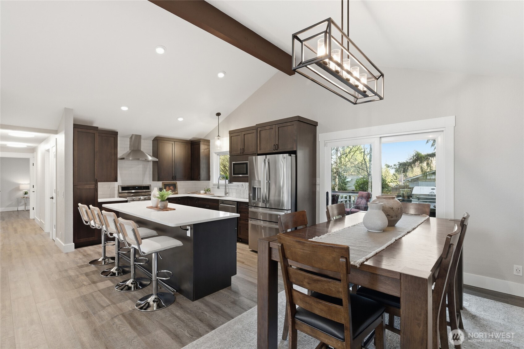 13011 Seattle Hill Road Snohomish, WA 98296 - Photo 10 of 40 a kitchen with a dining table chairs stainless steel appliances and cabinets