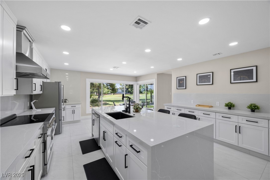 3482 Pueblo Way Las Vegas, NV 89169 - Photo 11 of 55 Stainless steel appliances and an oversized island create a kitchen that’s both functional and elegant.