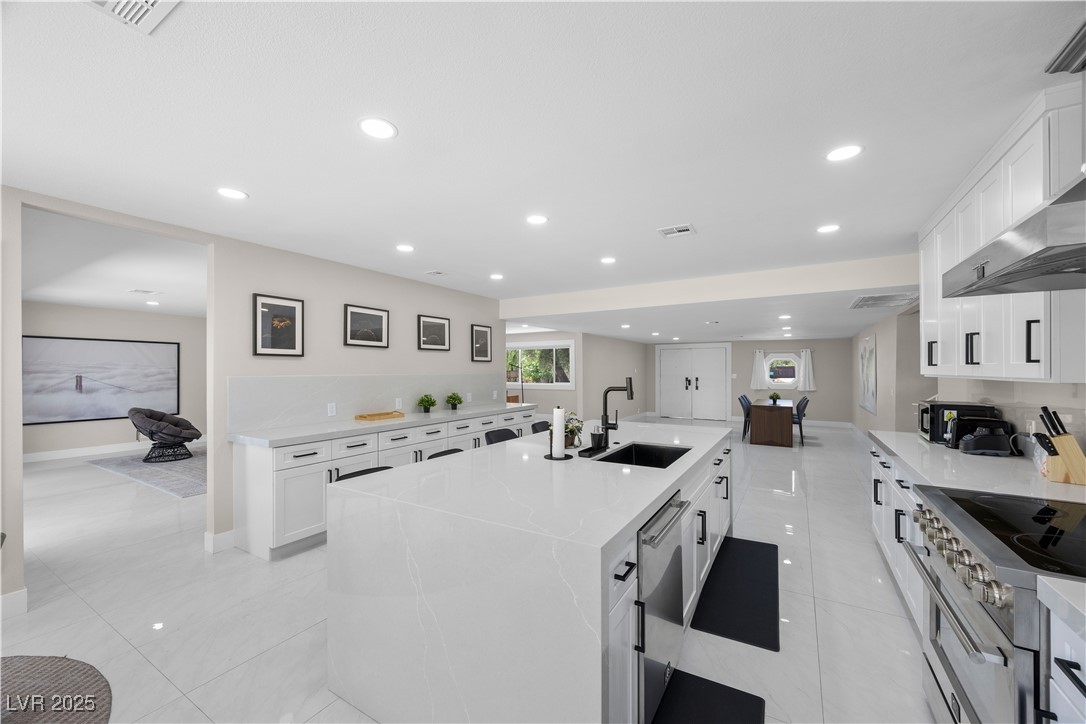 3482 Pueblo Way Las Vegas, NV 89169 - Photo 12 of 55 The open-concept design effortlessly connects the kitchen and living room, making entertaining and everyday living a breeze.