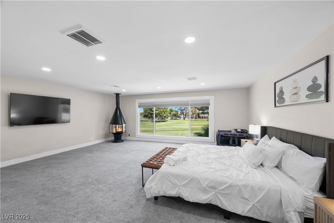 3482 Pueblo Way Las Vegas, NV 89169 - Photo 16 of 55 A beautiful fusion of indoor comfort and outdoor inspiration in this primary bedroom overlooking the golf course.