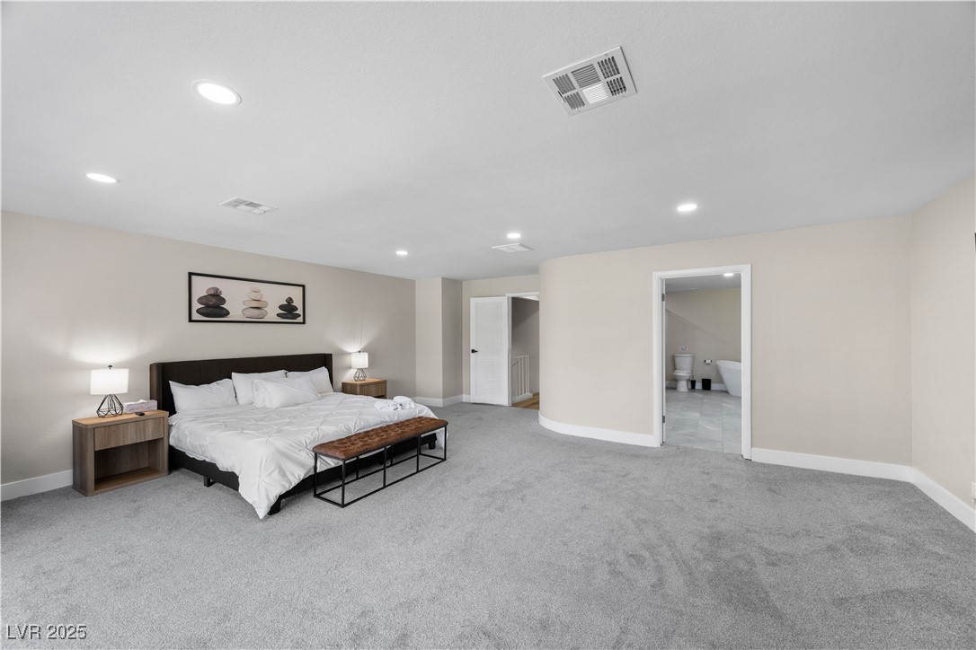 3482 Pueblo Way Las Vegas, NV 89169 - Photo 17 of 55 Primary bedroom with elegant finishes, large ensuite, and a fireplace that anchors the space with warmth.