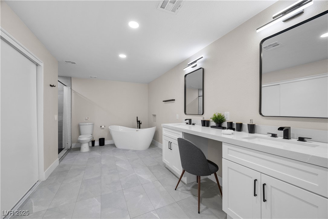 3482 Pueblo Way Las Vegas, NV 89169 - Photo 20 of 55 Enjoy elevated everyday luxury in this ensuite featuring a classic tub and a separate shower with stylish detailing.