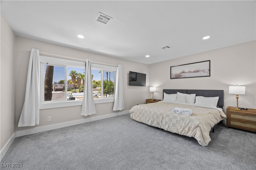 3482 Pueblo Way Las Vegas, NV 89169 - Photo 21 of 55 This spacious second bedroom boasts a private ensuite, generous closet and ample natural light!