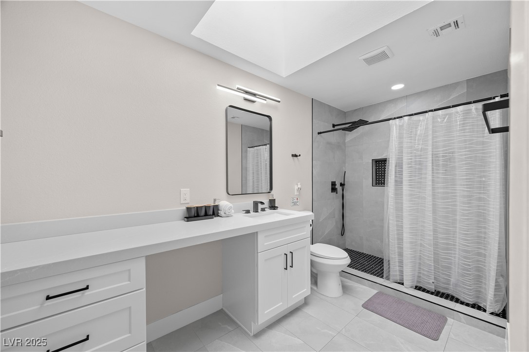 3482 Pueblo Way Las Vegas, NV 89169 - Photo 28 of 55 Full bathroom with vanity, a tile shower, tile patterned flooring, and recessed lighting