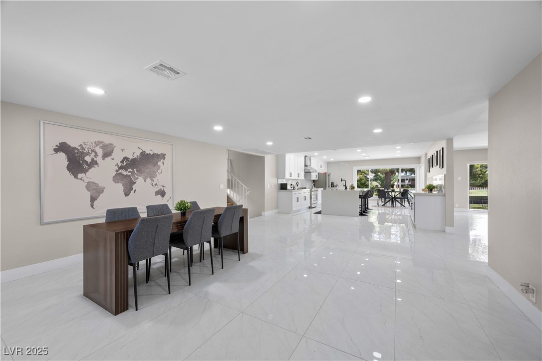 3482 Pueblo Way Las Vegas, NV 89169 - Photo 4 of 55 A modern open layout unites the dining area with the kitchen, featuring clean lines and thoughtful functionality.