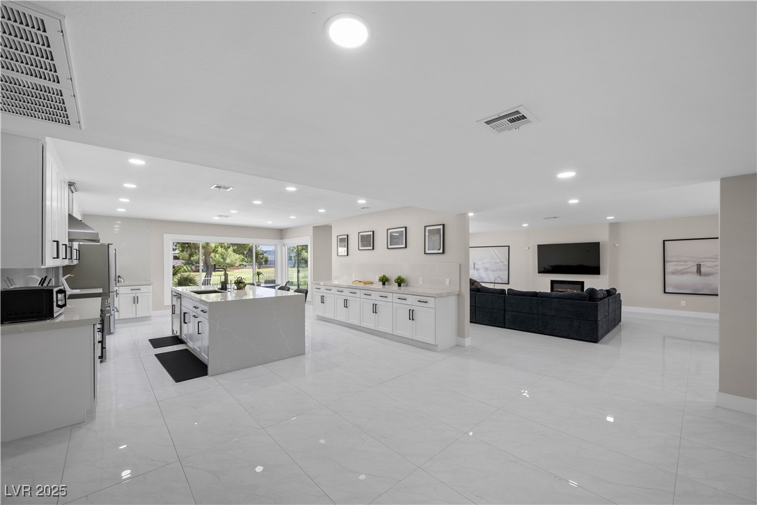 3482 Pueblo Way Las Vegas, NV 89169 - Photo 10 of 55 Modern kitchen blends effortlessly with the spacious living area.