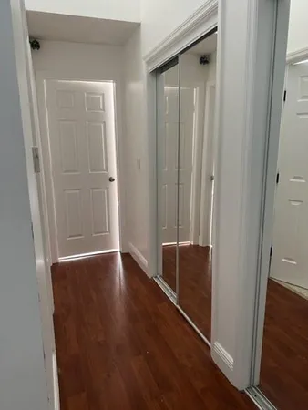 a view of walk in closet with wooden floor