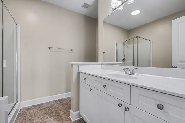 a view of empty room with wooden floor and a window