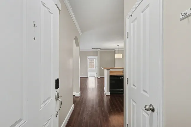 a view of a hallway with wooden floor and staircase