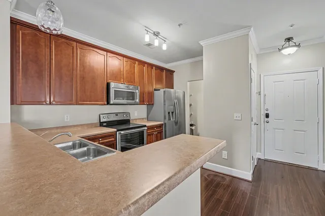 a kitchen with wooden cabinets and stainless steel appliances
