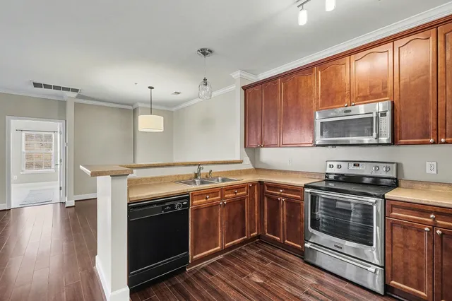 a kitchen with a stove sink and microwave