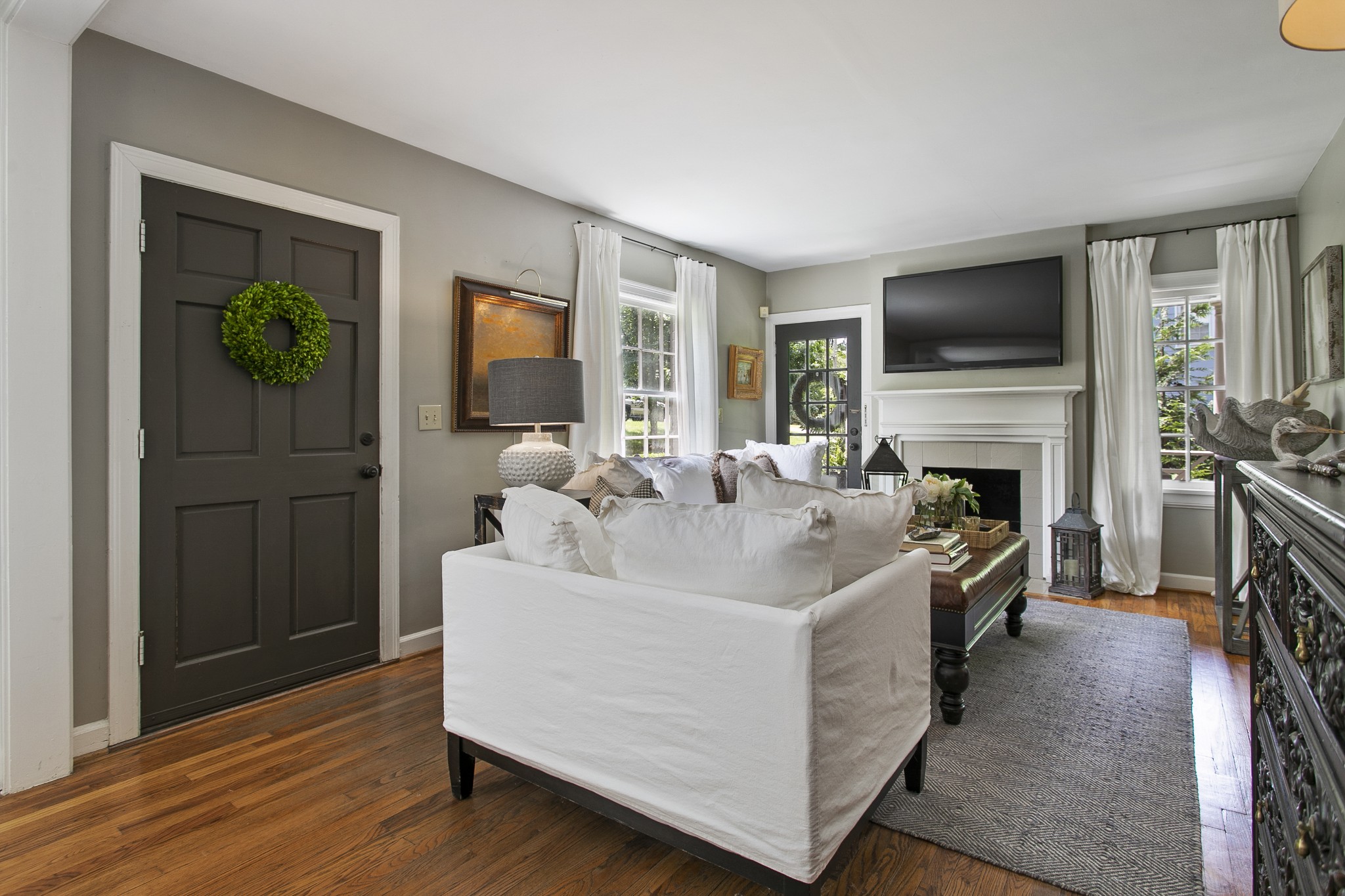 130 Spring Valley Road Nashville, TN 37214 - Photo 7 of 46 a living room with furniture a flat screen tv and a fireplace