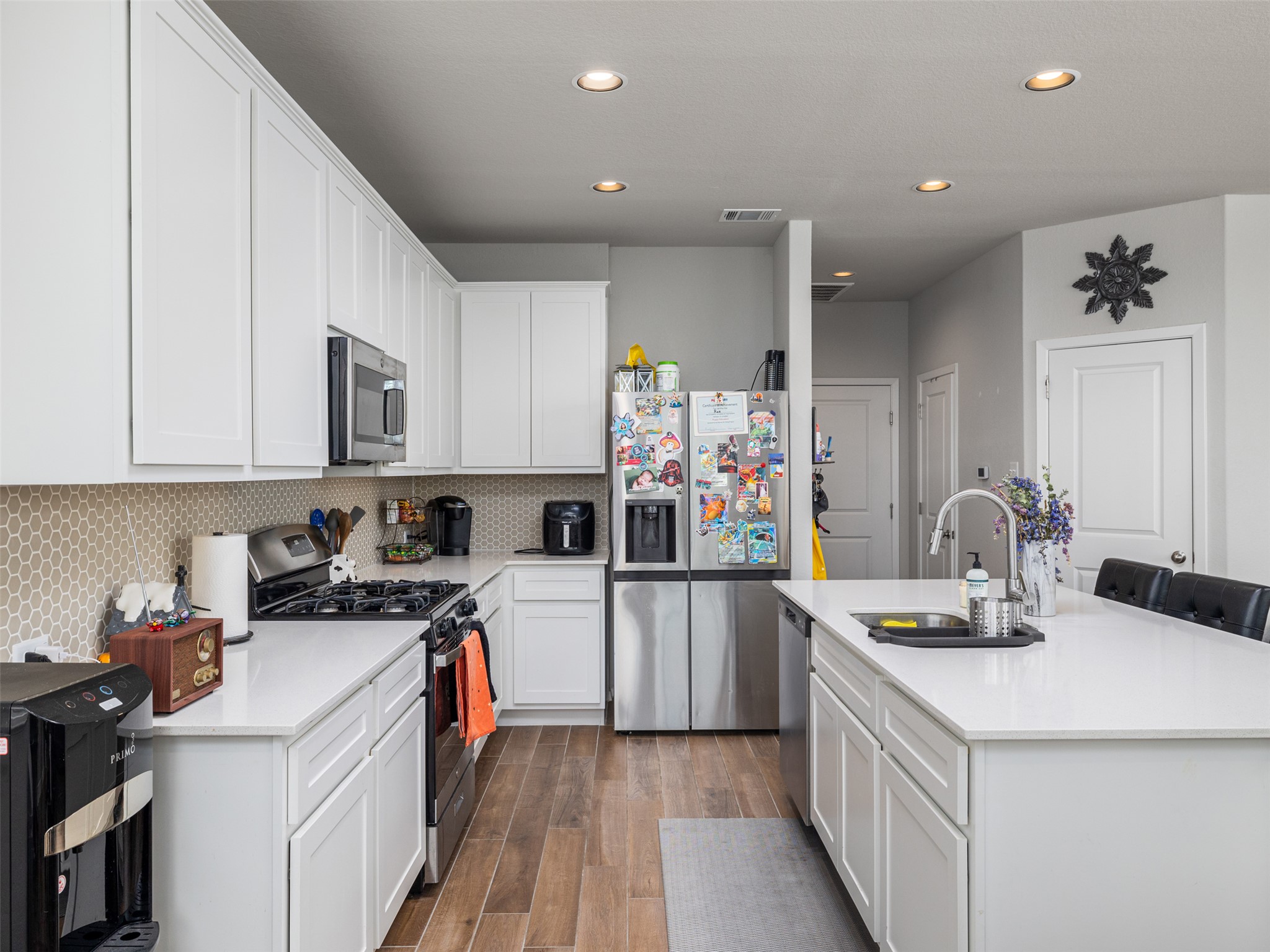 121 Graver Street Georgetown, TX 78626 - Photo 9 of 28 Prepare meals with ease in this well-appointed kitchen featuring a functional island.