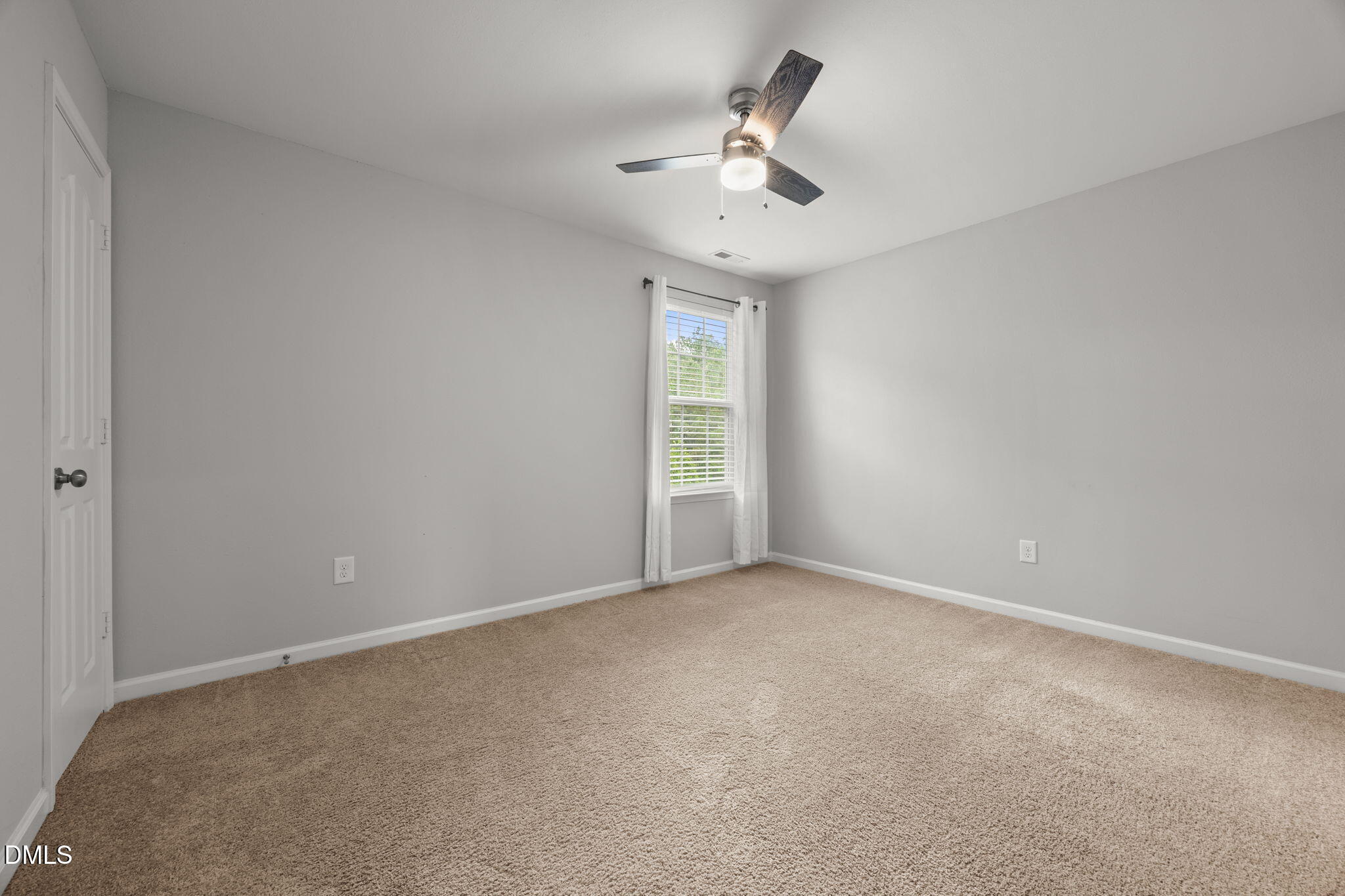 45 Crane Way Bunnlevel, NC 28323 - Photo 30 of 35 an empty room with a chandelier fan and windows
