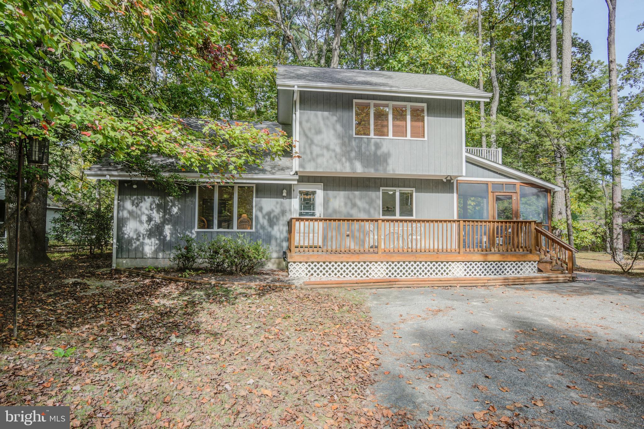 19 Capetown Road Ocean Pines, MD 21811 - Photo 14 of 56 a front view of a house with a yard and trees