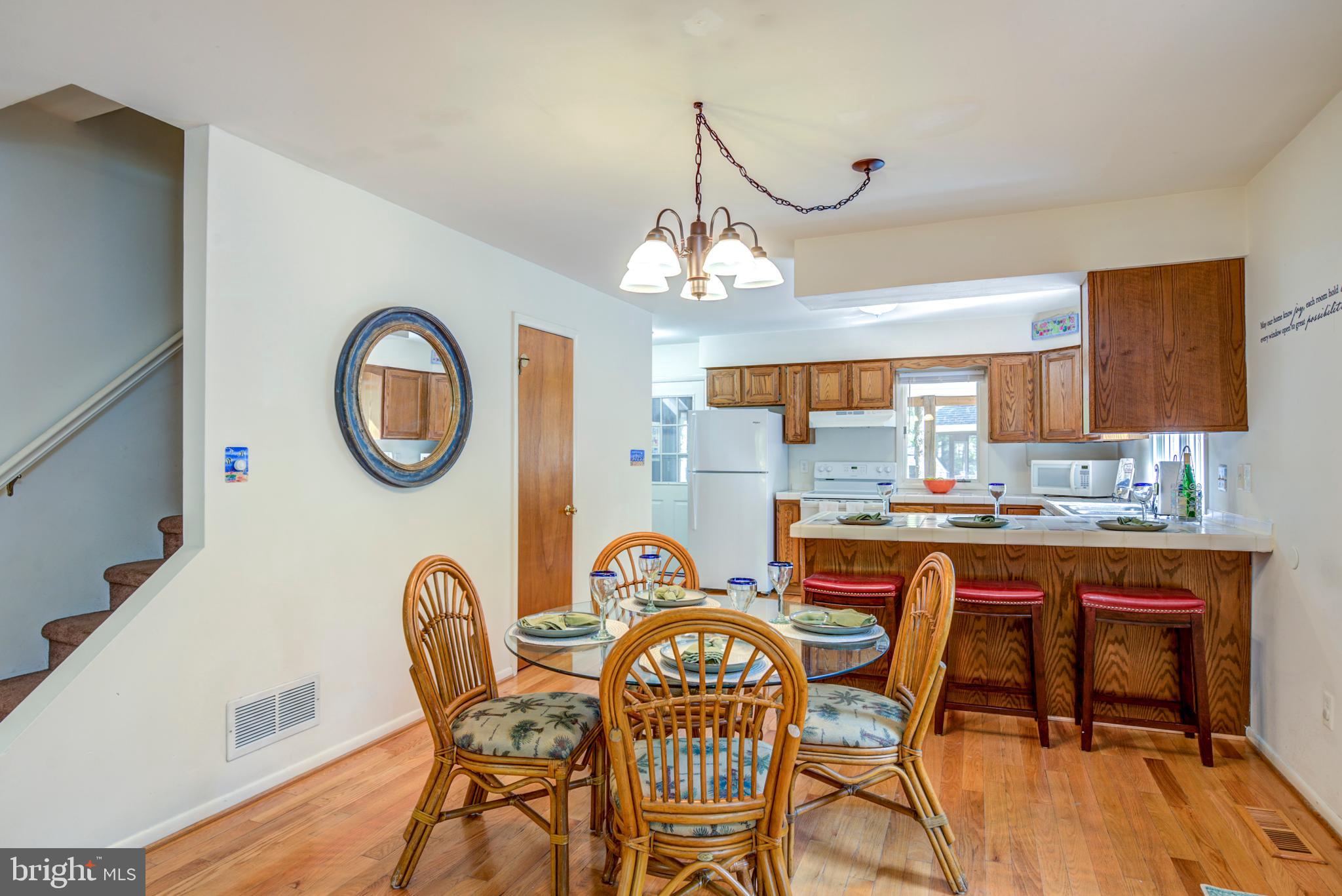 19 Capetown Road Ocean Pines, MD 21811 - Photo 3 of 56 a dining room filled chandelier and wooden floor