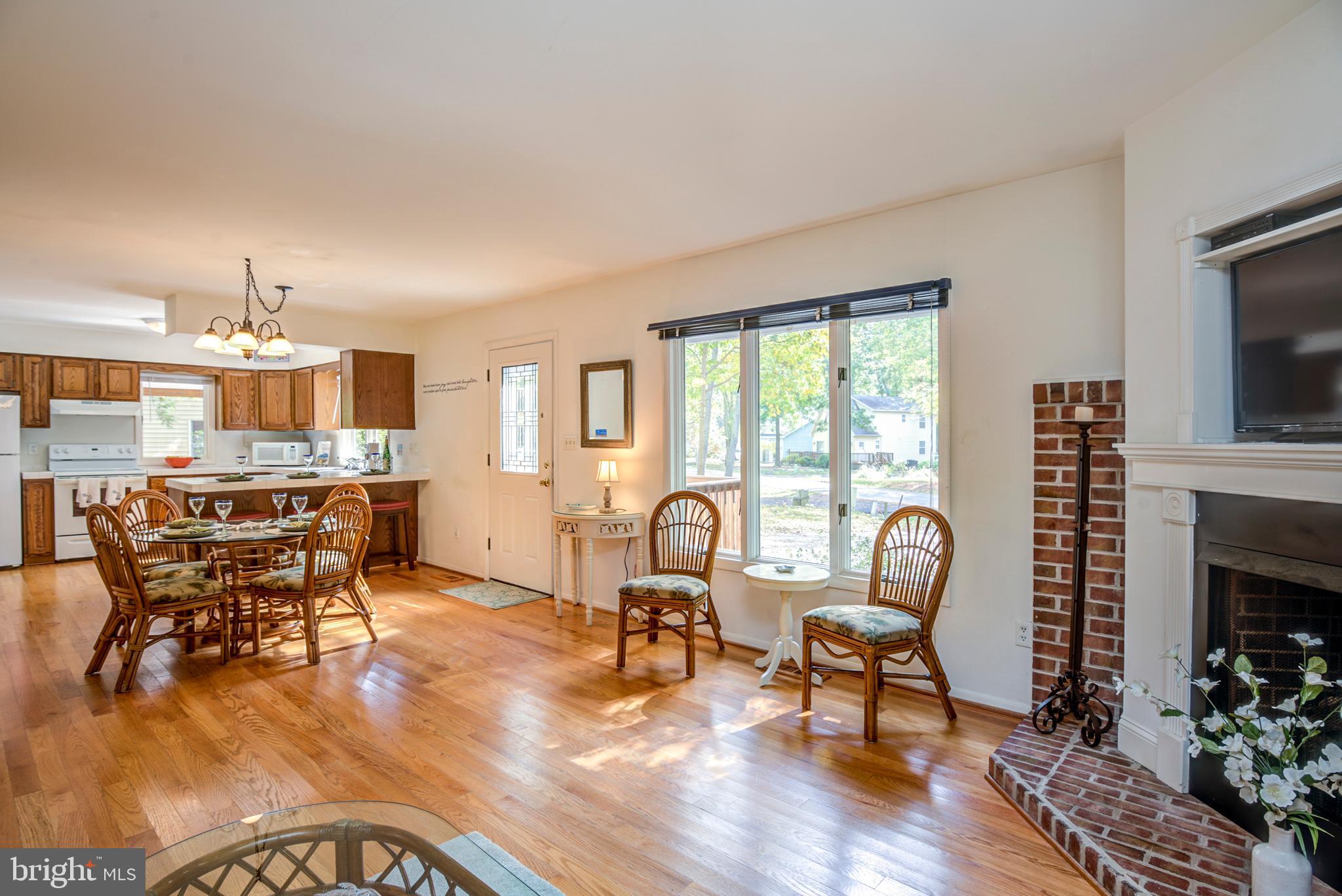 19 Capetown Road Ocean Pines, MD 21811 - Photo 22 of 56 a living room with furniture a dining table and a fireplace