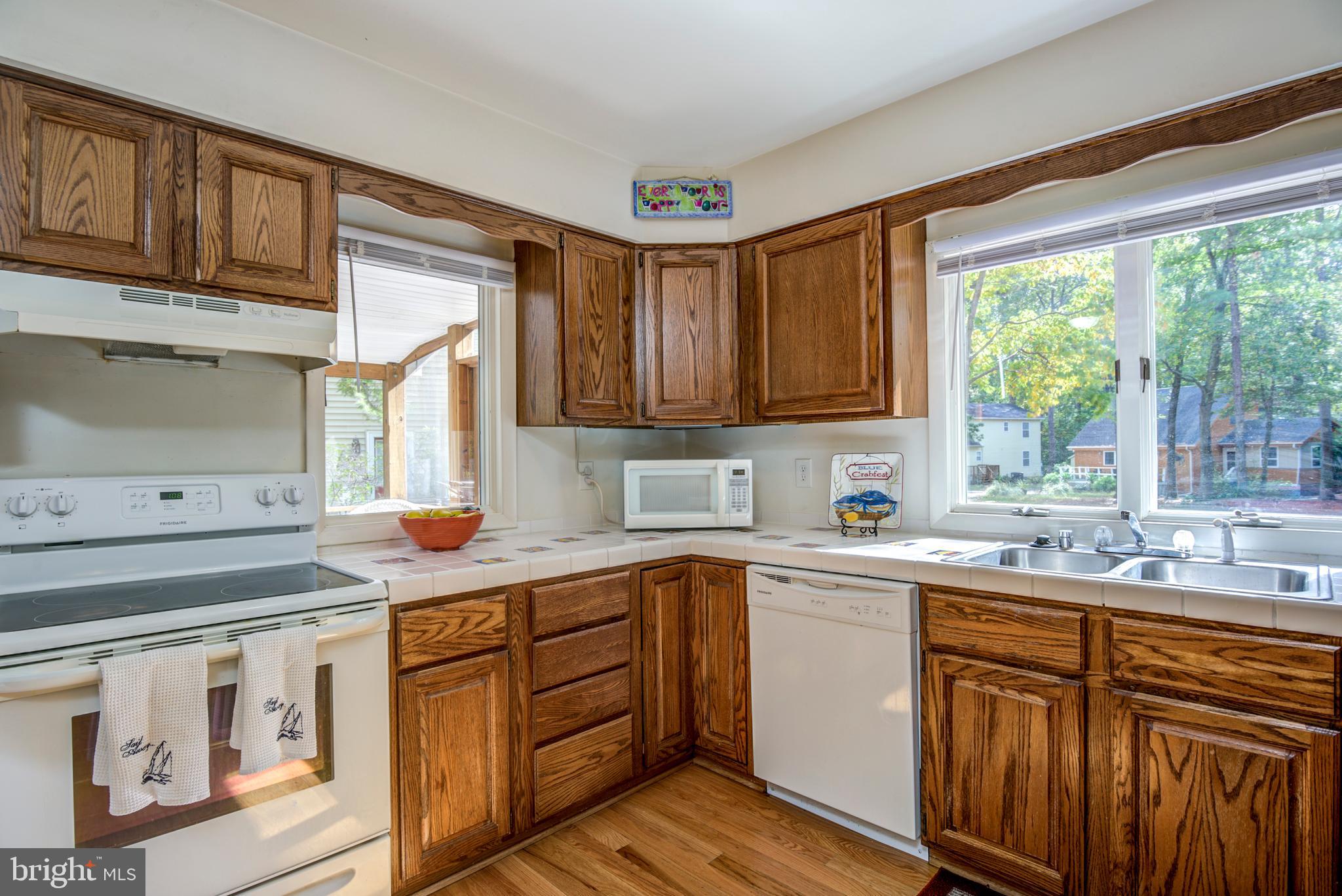 19 Capetown Road Ocean Pines, MD 21811 - Photo 27 of 56 a kitchen with kitchen island granite countertop a sink stove and cabinets