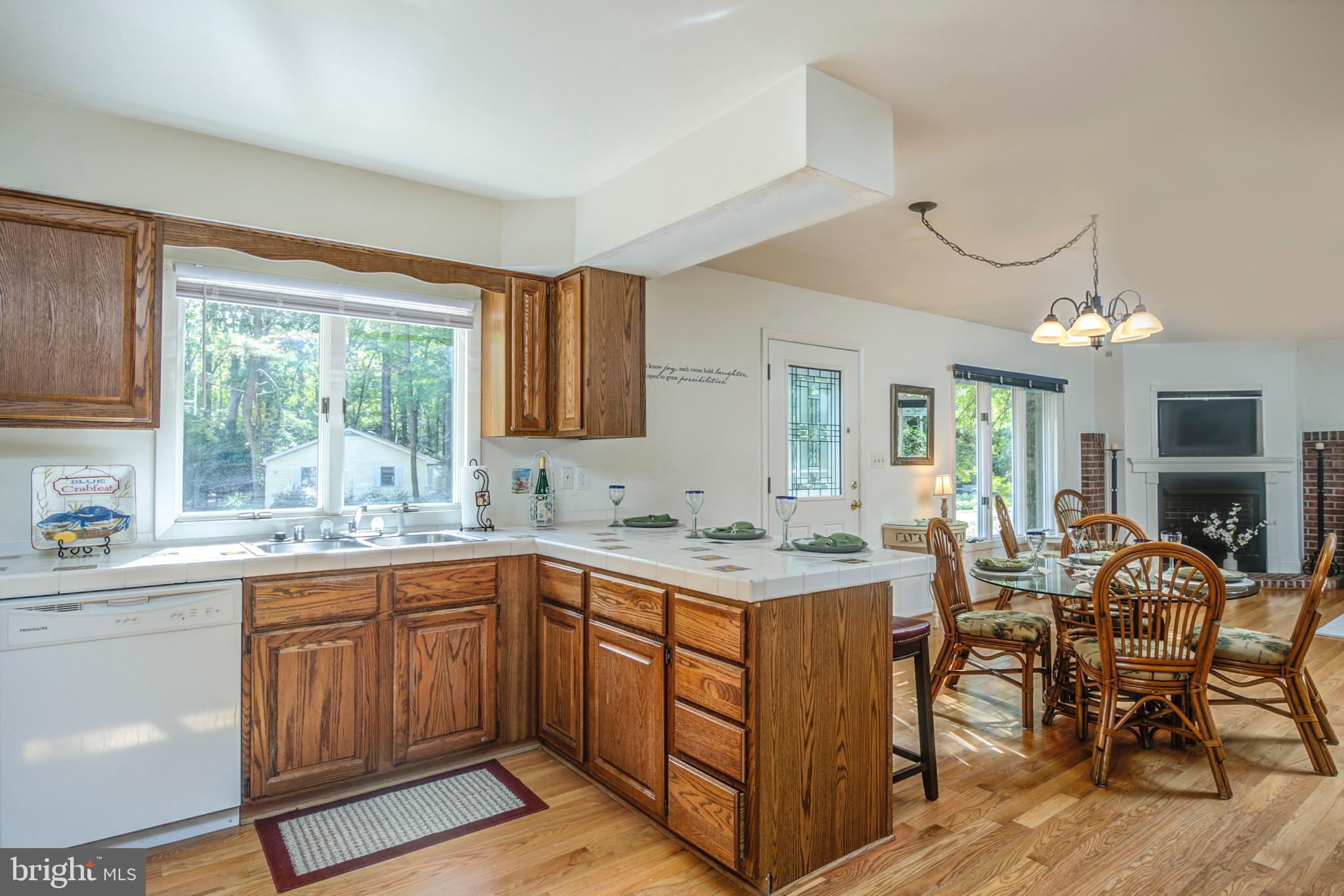 19 Capetown Road Ocean Pines, MD 21811 - Photo 29 of 56 a kitchen with a sink a window and chairs