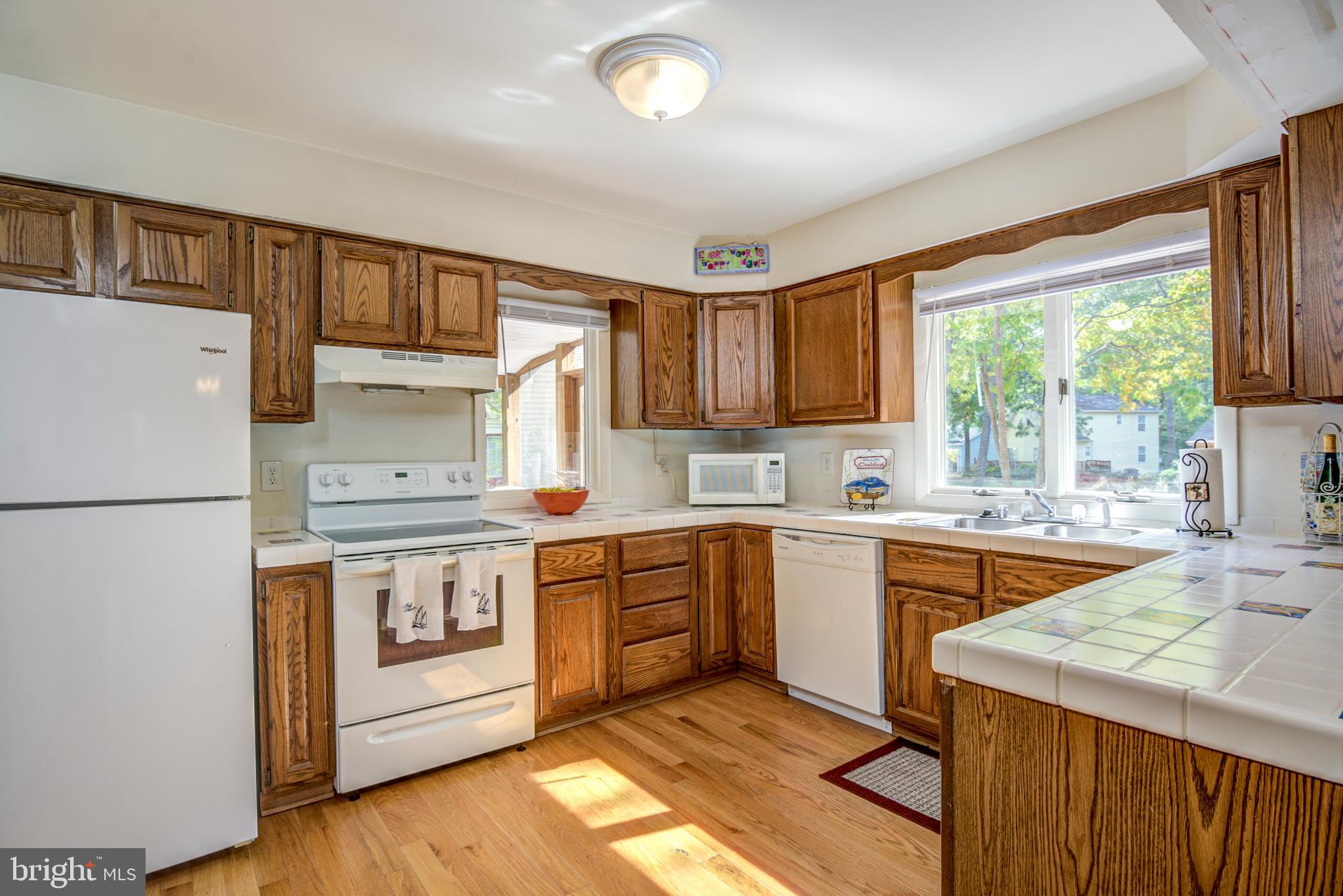 19 Capetown Road Ocean Pines, MD 21811 - Photo 4 of 56 a kitchen with a stove a sink and a refrigerator