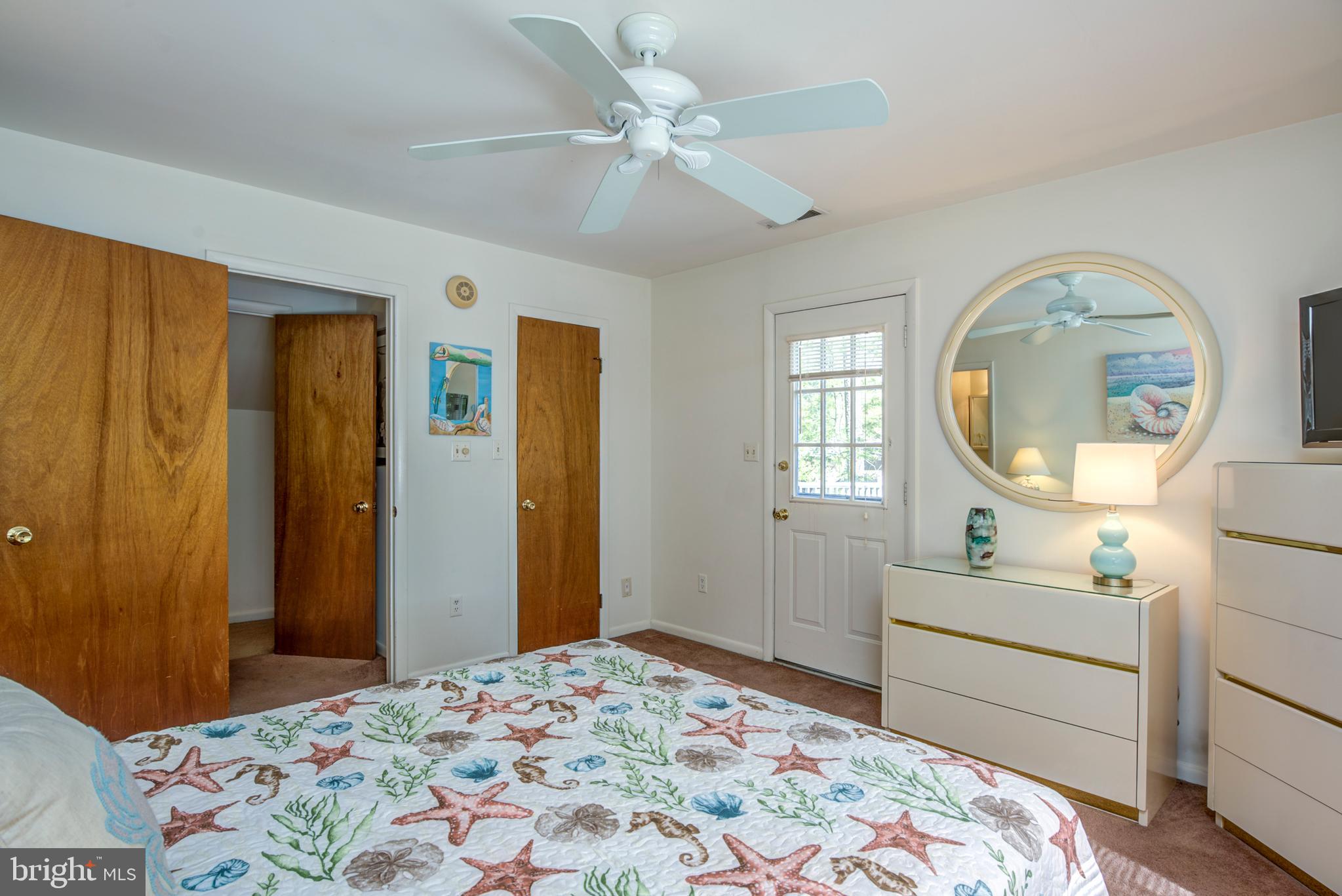 19 Capetown Road Ocean Pines, MD 21811 - Photo 33 of 56 a bedroom with a bed and a mirror