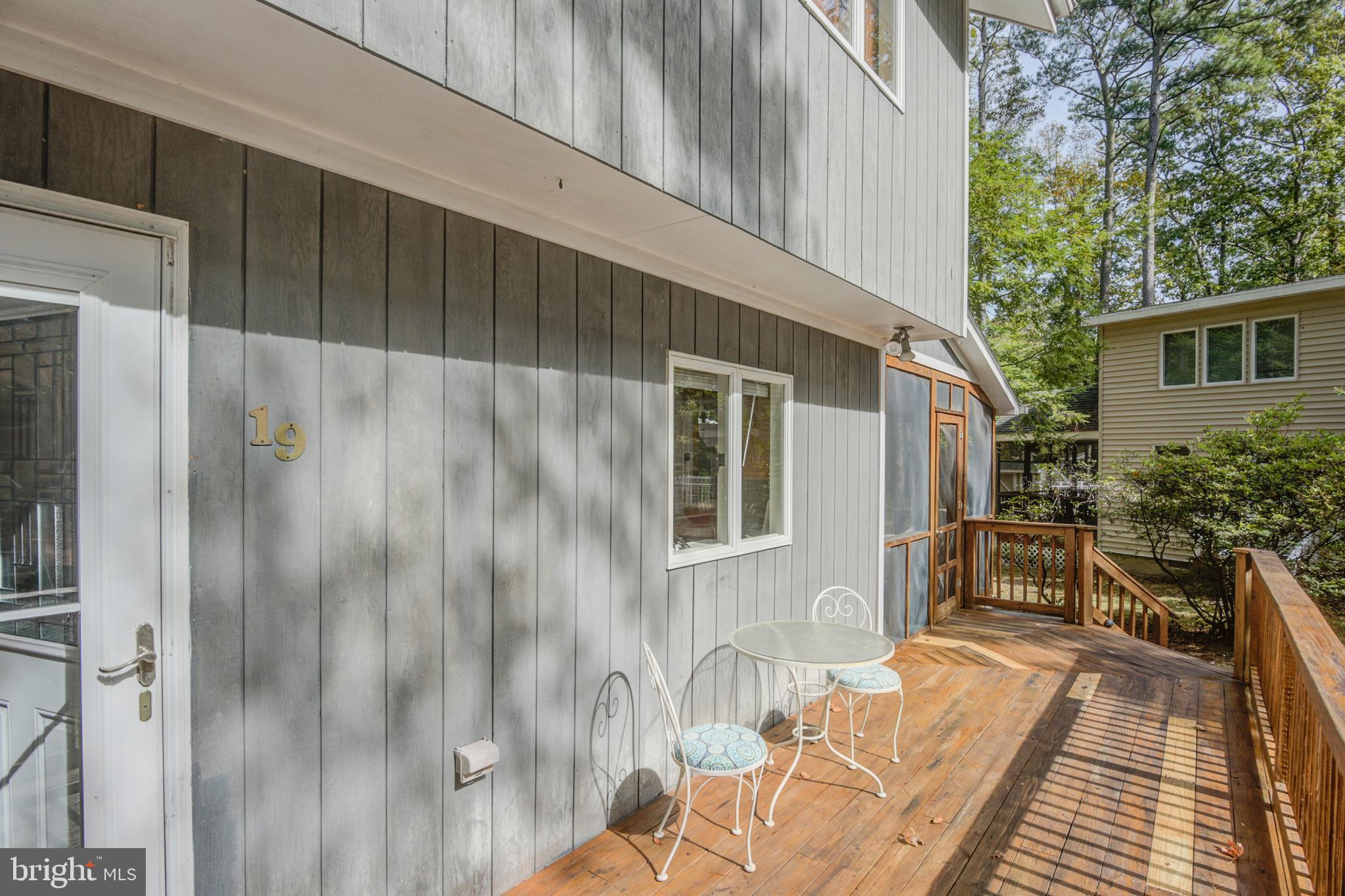 19 Capetown Road Ocean Pines, MD 21811 - Photo 37 of 56 a backyard of a house with wooden floor a barbeque oven and outdoor seating