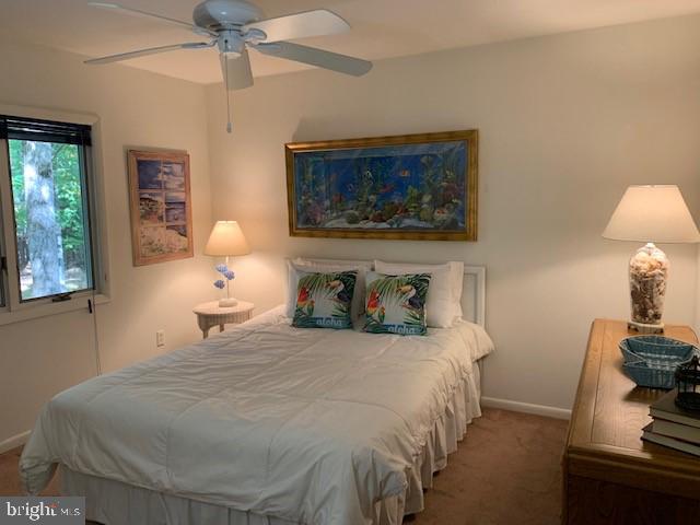 19 Capetown Road Ocean Pines, MD 21811 - Photo 44 of 56 a bedroom with a bed and a lamp on dresser