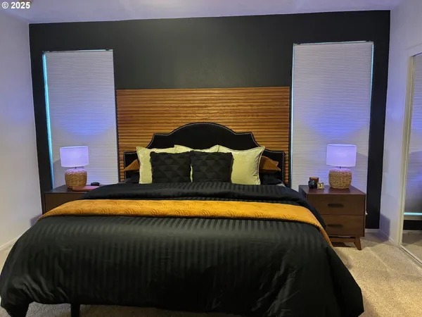 a bedroom with a bed and a potted plant