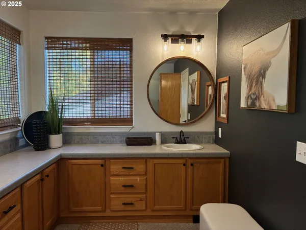 a bathroom with a toilet a sink and a mirror
