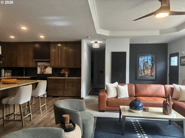 a living room with furniture and kitchen view