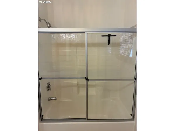 a bathroom with a glass shower door